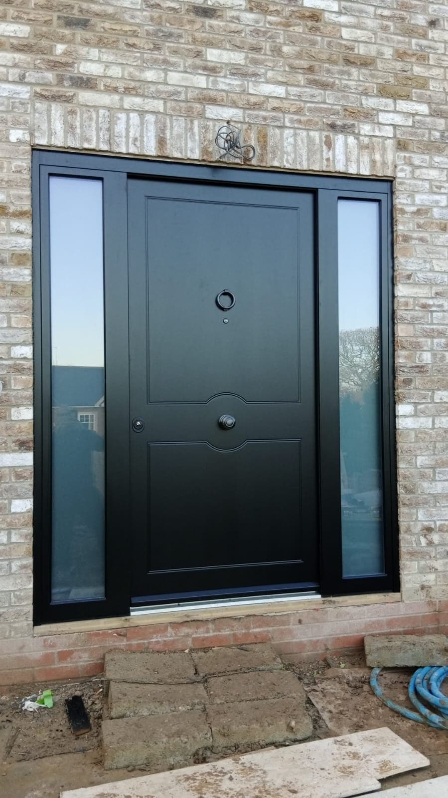 Black contemporary steel door with dual sidelights