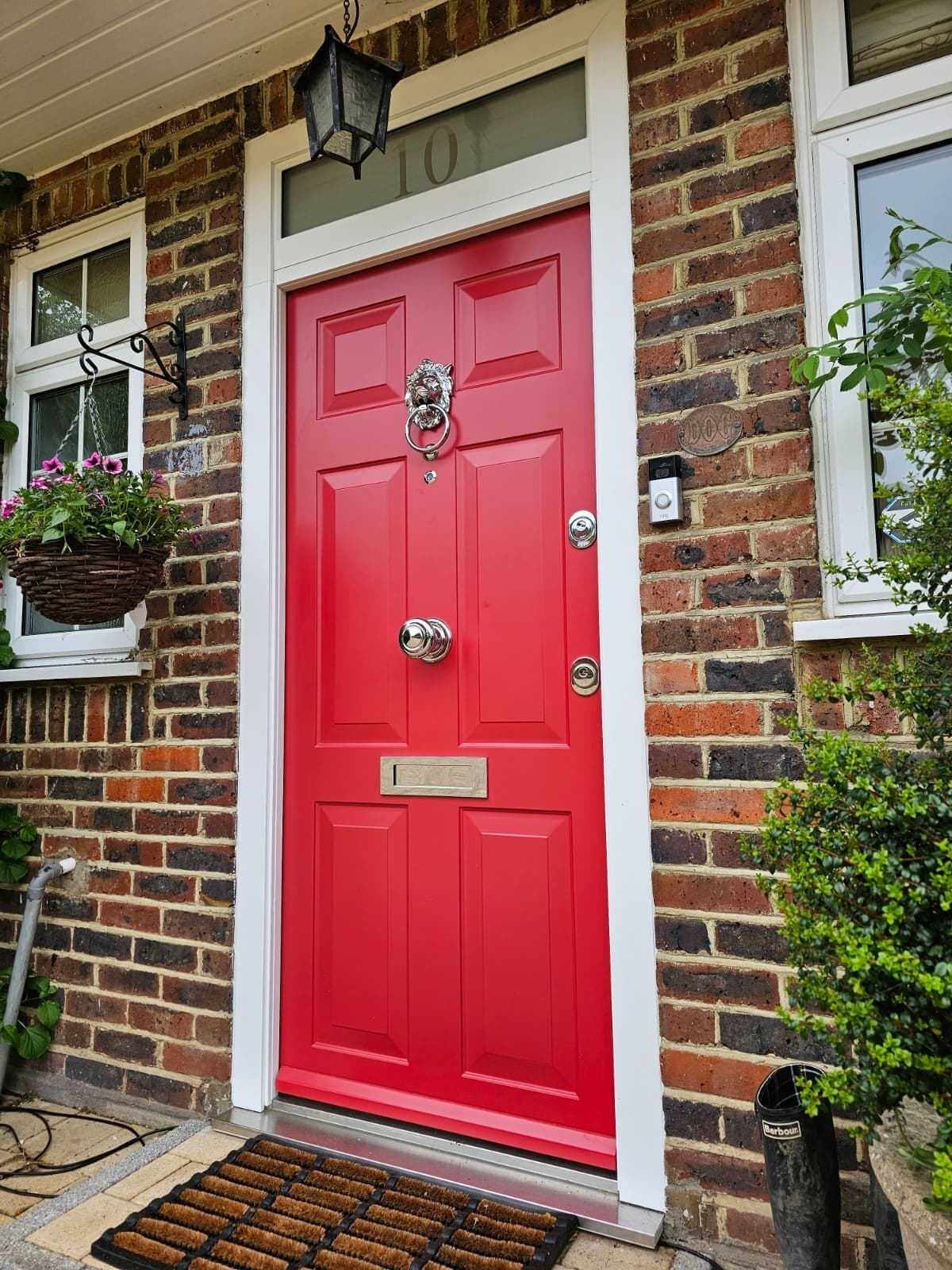 Red traditional steel door with lion knocker