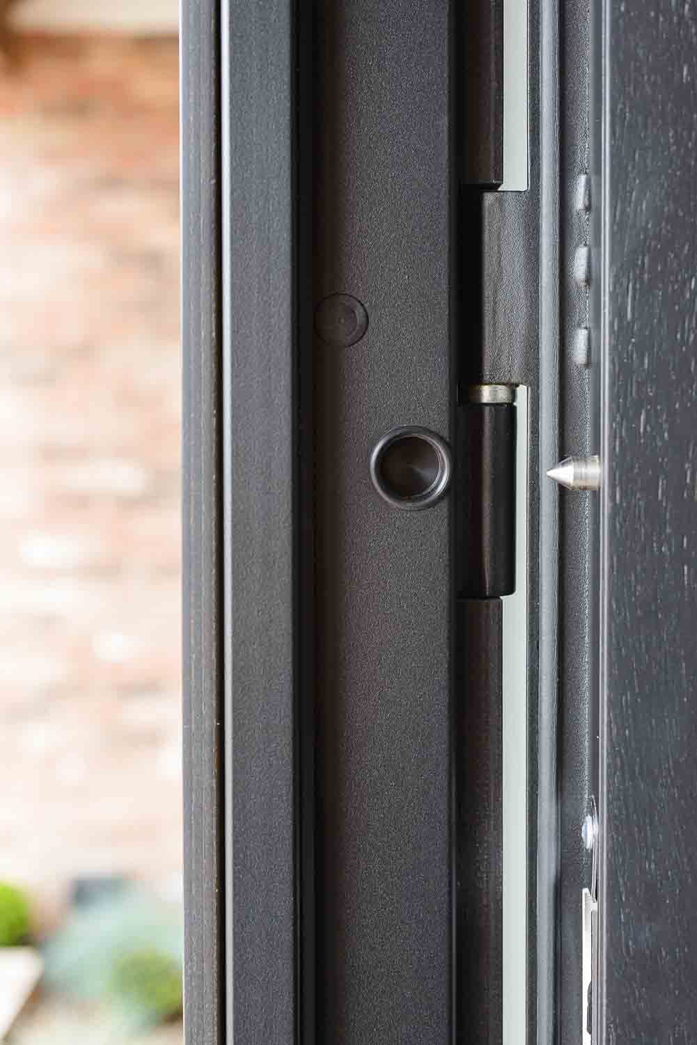 Engineered hinge and locking pin detail on a SteelR steel front door, illustrating the golden-thread documentary chain under the Building Safety Act 2022