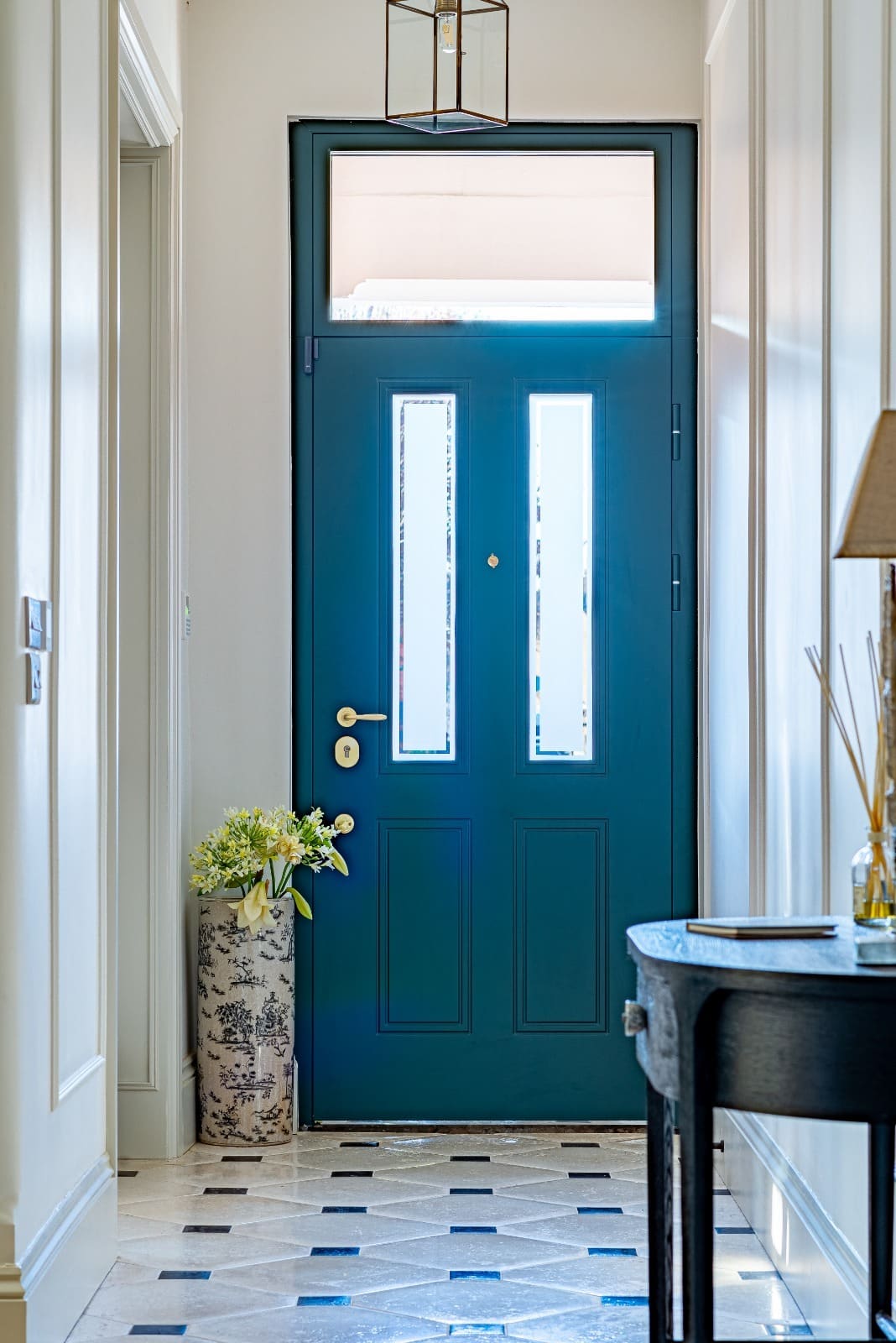 Teal panelled steel entrance door with glass hallway — composite vs steel doors 2026 comparison