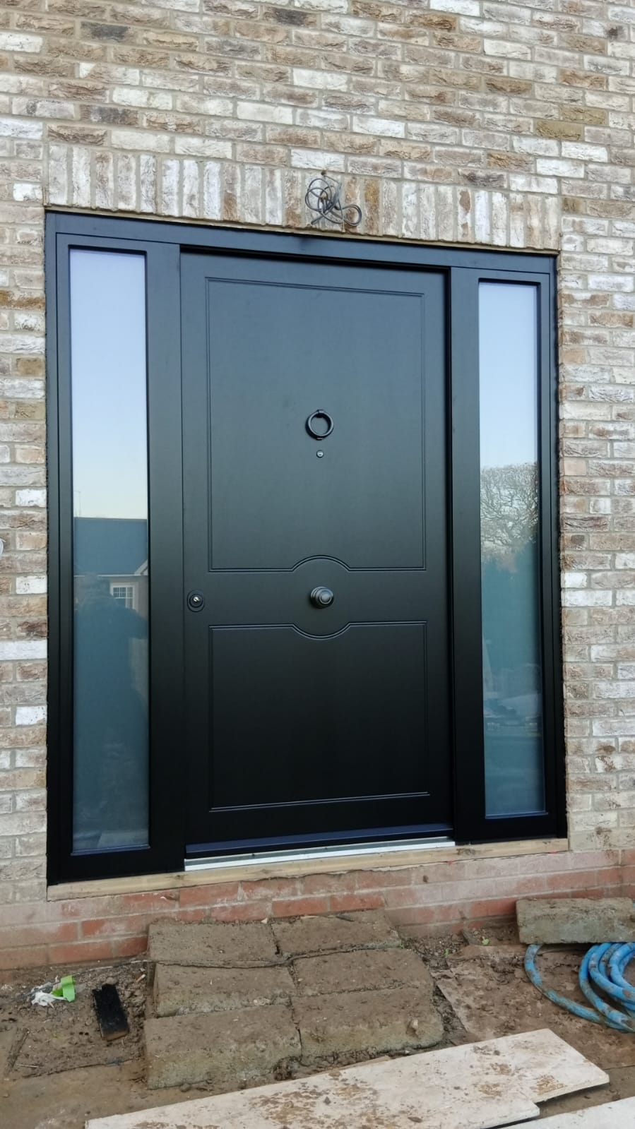 Black contemporary steel door with dual sidelights