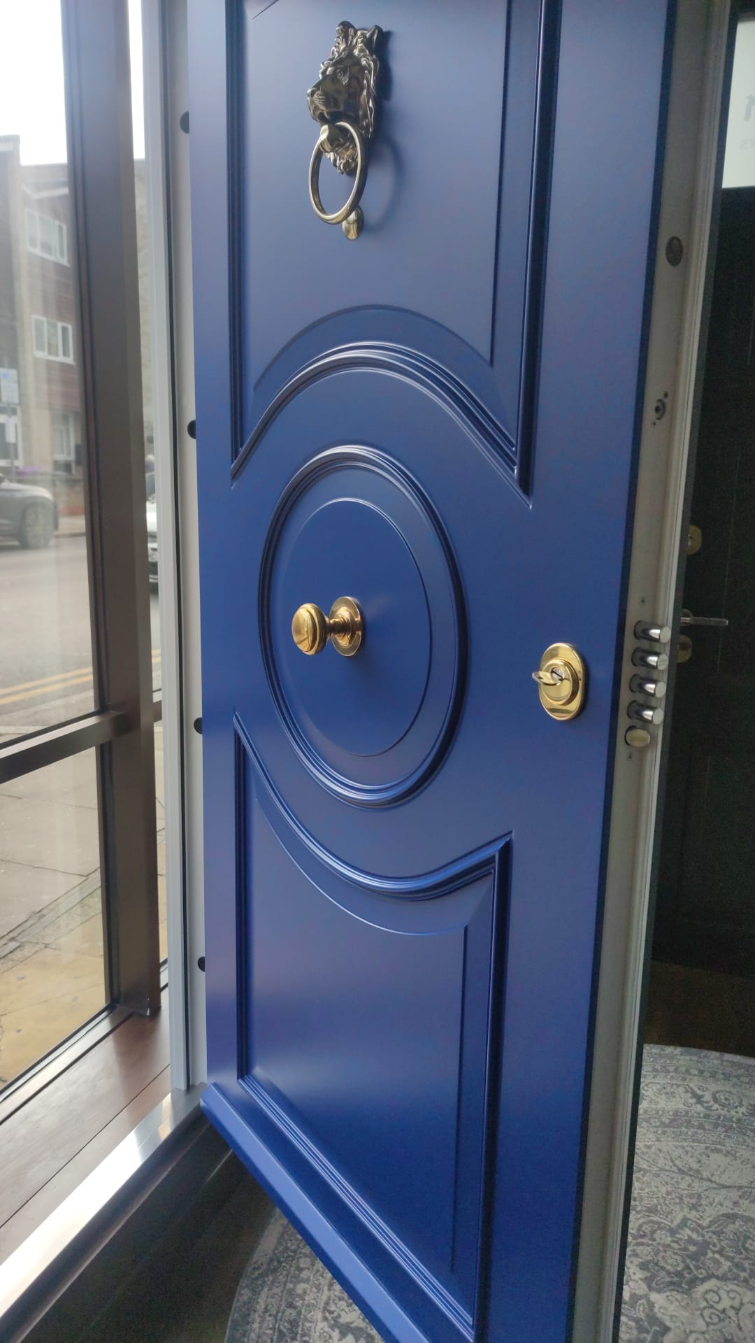 Cobalt blue ornate steel door with lion knocker