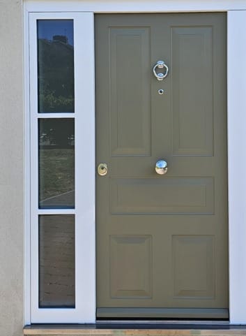 Olive panelled steel door with ring knocker and sidelight
